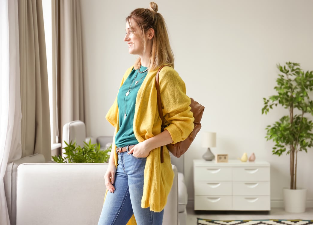 Woman in Yellow Cardigan with Leather Backpack