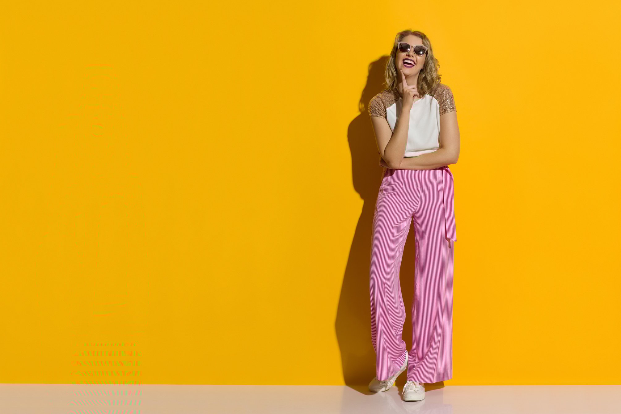 Laughing Young Woman In Striped Wide Legs Trousers And Sunglasses